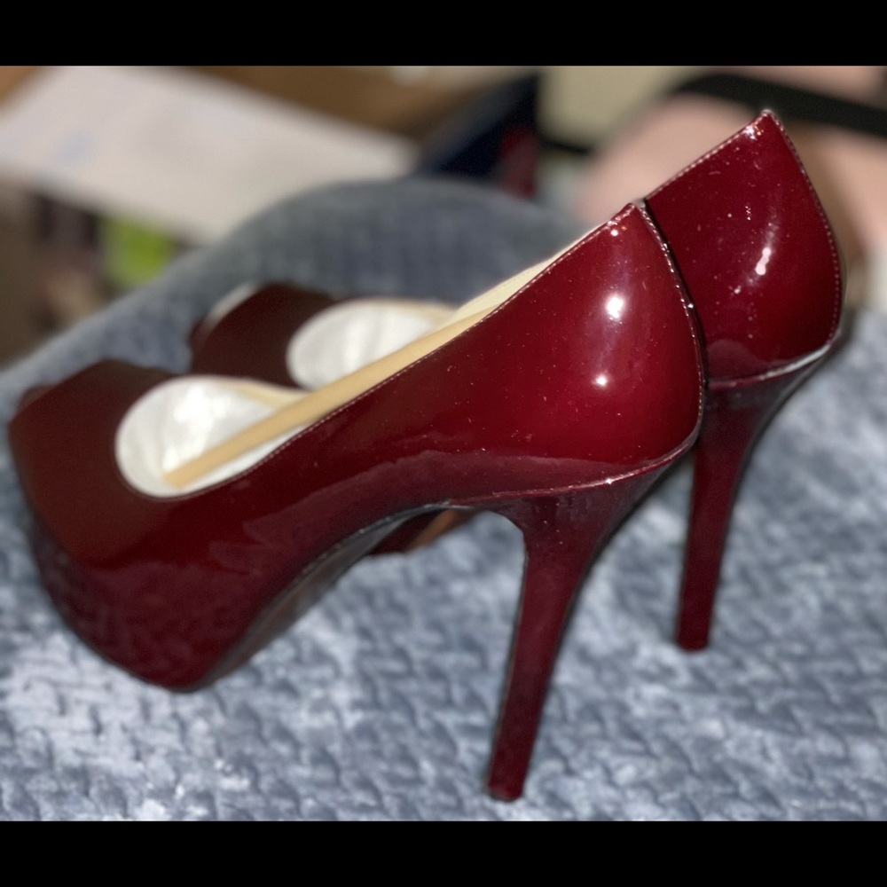 Patent leather peep-toe cranberry pumps